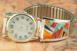 Genuine Spiny Oyster Shell, Turquoise and Blue Lapis inlaid between ribbons of Sterling Silver. Beautiful Mother of Pearl Accents. Mens quartz watch with expandable band. Designed by Navajo Artist Calvin Begay. Signed.